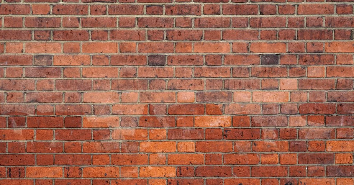 Imagen detallada de una pared de ladrillos rojos, ideal para usar como textura de fondo.